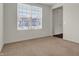 Empty bedroom with neutral carpet, light gray walls, and window with view of neighborhood at 6075 Meadowview Dr, Whitestown, IN 46075