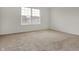 A clean, empty bedroom featuring neutral carpet, white walls, and natural light at 6075 Meadowview Dr, Whitestown, IN 46075