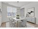This dining room features a modern light fixture, a marble dining table, and six chairs with neutral tones at 6075 Meadowview Dr, Whitestown, IN 46075