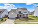 Two-story home with a two-car garage, brick accents, and well-maintained lawn in a suburban neighborhood at 6075 Meadowview Dr, Whitestown, IN 46075