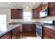 Spacious kitchen featuring stainless steel appliances, granite countertops, and wood cabinetry at 6075 Meadowview Dr, Whitestown, IN 46075