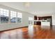 Open floor plan with hardwood floors, and view of the kitchen, dining area, and large windows at 6075 Meadowview Dr, Whitestown, IN 46075