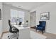 This office offers a modern desk and black office chair with the addition of a comfortable blue wingback chair at 6075 Meadowview Dr, Whitestown, IN 46075
