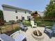 Spacious backyard featuring a fire pit with chairs and a wooden playset providing relaxation and entertainment at 6345 Meadowview Dr, Whitestown, IN 46075