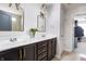 Bathroom featuring dual sinks, dark wood cabinetry with gold hardware, and updated decor at 6345 Meadowview Dr, Whitestown, IN 46075