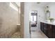 Updated bathroom features a shower stall and a view into the bedroom, with dual sinks and brown cabinets at 6345 Meadowview Dr, Whitestown, IN 46075