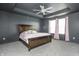 Comfortable bedroom features gray walls, a tray ceiling, and a rustic wood bed with a pink comforter set at 6345 Meadowview Dr, Whitestown, IN 46075