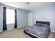 Cozy bedroom with a light blue accent wall, plush carpet, and a window with natural light at 6345 Meadowview Dr, Whitestown, IN 46075