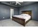 This lovely bedroom features gray walls, an open door to the bathroom, and a rustic wood bed at 6345 Meadowview Dr, Whitestown, IN 46075