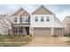 Charming two-story home with three-car garage, brick accents, and welcoming front porch at 6345 Meadowview Dr, Whitestown, IN 46075