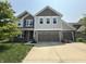 Charming two-story home with a three-car garage and well-manicured lawn, providing great curb appeal at 6345 Meadowview Dr, Whitestown, IN 46075