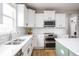 Bright kitchen featuring stainless steel appliances, white cabinets, and a subway tile backsplash at 6345 Meadowview Dr, Whitestown, IN 46075