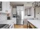Modern kitchen with stainless steel refrigerator, white cabinets, and stylish light fixtures at 6345 Meadowview Dr, Whitestown, IN 46075