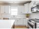Bright kitchen featuring stainless steel appliances, white cabinets, and a subway tile backsplash at 6345 Meadowview Dr, Whitestown, IN 46075
