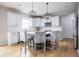 Modern kitchen with white cabinets, subway tile backsplash, stainless steel appliances, and a breakfast bar at 6345 Meadowview Dr, Whitestown, IN 46075