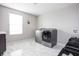 Well-lit laundry room with modern washer and dryer, white tile flooring, and storage cabinets at 6345 Meadowview Dr, Whitestown, IN 46075