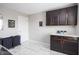 Laundry room with dark wood cabinets, white countertops, and a clean, well-lit space at 6345 Meadowview Dr, Whitestown, IN 46075