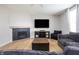 Cozy living room with a fireplace, large television, comfortable sofa, and hardwood floors at 6345 Meadowview Dr, Whitestown, IN 46075