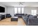 Spacious living room featuring an L-shaped sofa, large windows, hardwood floors, and modern decor at 6345 Meadowview Dr, Whitestown, IN 46075