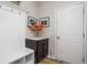 Mudroom featuring a built-in storage bench, coat hooks, and a decorative vase with colorful flowers at 6345 Meadowview Dr, Whitestown, IN 46075