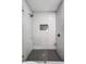 Contemporary shower with white subway tile and a gray accent niche; features a frameless glass door at 6345 Meadowview Dr, Whitestown, IN 46075
