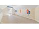 Finished attic space with carpet and painted college logos on the wall at 6516 Shamel Dr, Indianapolis, IN 46278