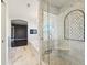 Elegant bathroom featuring a glass-enclosed shower, marble tile, and seamless transition to the tub area at 6516 Shamel Dr, Indianapolis, IN 46278