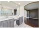 Bathroom with dual vanities, marble countertops, and ample storage; brightened by a large mirror at 6516 Shamel Dr, Indianapolis, IN 46278