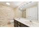Modern bathroom with double sink vanity, stone accent wall, and large mirror at 6516 Shamel Dr, Indianapolis, IN 46278