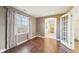 Spacious bedroom featuring hardwood floors, a large window with drapes, and an en suite bathroom at 6516 Shamel Dr, Indianapolis, IN 46278