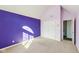 Spacious bedroom with purple accent wall, double door closet, and neutral carpet at 6516 Shamel Dr, Indianapolis, IN 46278