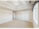 Neutral bedroom featuring a tray ceiling, double closet doors and a large window with custom valance at 6516 Shamel Dr, Indianapolis, IN 46278