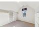 Well-organized closet space with shelving and hanging rods, complemented by a bright window at 6516 Shamel Dr, Indianapolis, IN 46278