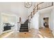 Bright foyer features a grand staircase with decorative carpet and tile flooring at 6516 Shamel Dr, Indianapolis, IN 46278