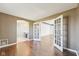 Bright hallway with hardwood floors and an open view into the adjacent rooms through glass panel french doors at 6516 Shamel Dr, Indianapolis, IN 46278