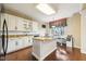 White kitchen features an island with seating and a breakfast nook at 6516 Shamel Dr, Indianapolis, IN 46278