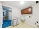 Functional laundry room with sink, wooden cabinets, and additional storage solutions at 6516 Shamel Dr, Indianapolis, IN 46278