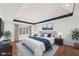 Well-lit primary bedroom featuring a plush bed, tray ceiling, and stylish décor for a serene retreat at 6516 Shamel Dr, Indianapolis, IN 46278