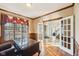 Office boasts hardwood floors, elegant wood trim, and a view through French doors at 6516 Shamel Dr, Indianapolis, IN 46278