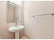 Clean and simple powder room with a pedestal sink and neutral color scheme at 6516 Shamel Dr, Indianapolis, IN 46278
