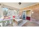 Cozy sunroom with brick wall and lots of windows overlooking the backyard, perfect for relaxation and enjoying natural light at 6516 Shamel Dr, Indianapolis, IN 46278