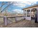 Wood deck with an entrance to a screened porch featuring furniture and exterior bench seating at 6516 Shamel Dr, Indianapolis, IN 46278