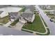 Aerial view of a well-kept property with a covered patio, lush lawn, and nearby pond at 7517 Heben Dr, Indianapolis, IN 46113