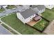 Aerial view of fenced backyard with a covered patio and lush grass, complete with neighboring homes at 7517 Heben Dr, Indianapolis, IN 46113