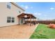 Residential backyard featuring an entertainment area and stamped concrete patio, and lush green grass at 7517 Heben Dr, Indianapolis, IN 46113