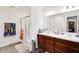 Bathroom with double vanity, framed mirrors, shower, and access to the closet at 7517 Heben Dr, Indianapolis, IN 46113