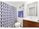 Cozy bathroom with vanity and blue patterned shower curtain at 7517 Heben Dr, Indianapolis, IN 46113
