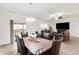 Open-concept dining area featuring modern light fixture, wood-look floors and access to the backyard at 7517 Heben Dr, Indianapolis, IN 46113