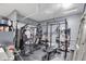 A home gym equipped with weightlifting equipment, including racks, benches, and a punching bag at 7517 Heben Dr, Indianapolis, IN 46113