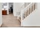 View of the open foyer with wood floors and a staircase with white banisters at 7517 Heben Dr, Indianapolis, IN 46113